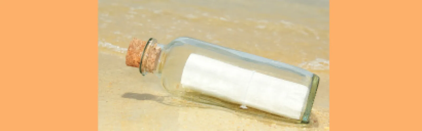 Message in a bottle sitting on sand with an orange background