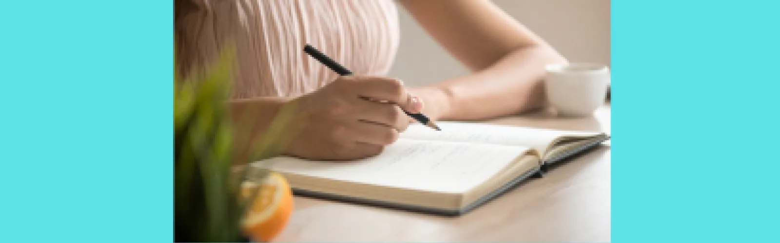 A woman with pen writing 