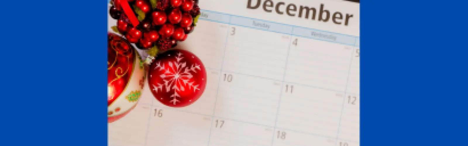 December calendar with Christmas ornaments and a plaid bow on top