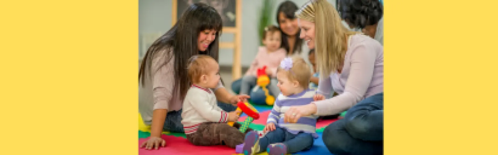 Mothers and young children interacting and playing with toys
