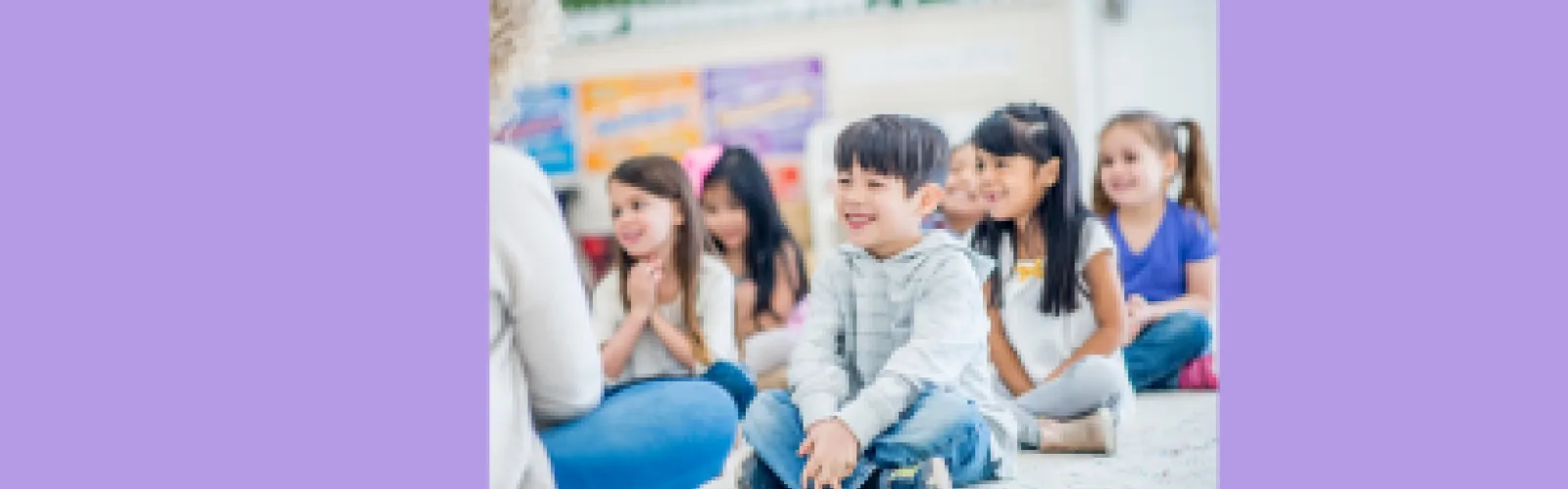 Group of children facing an adult reader