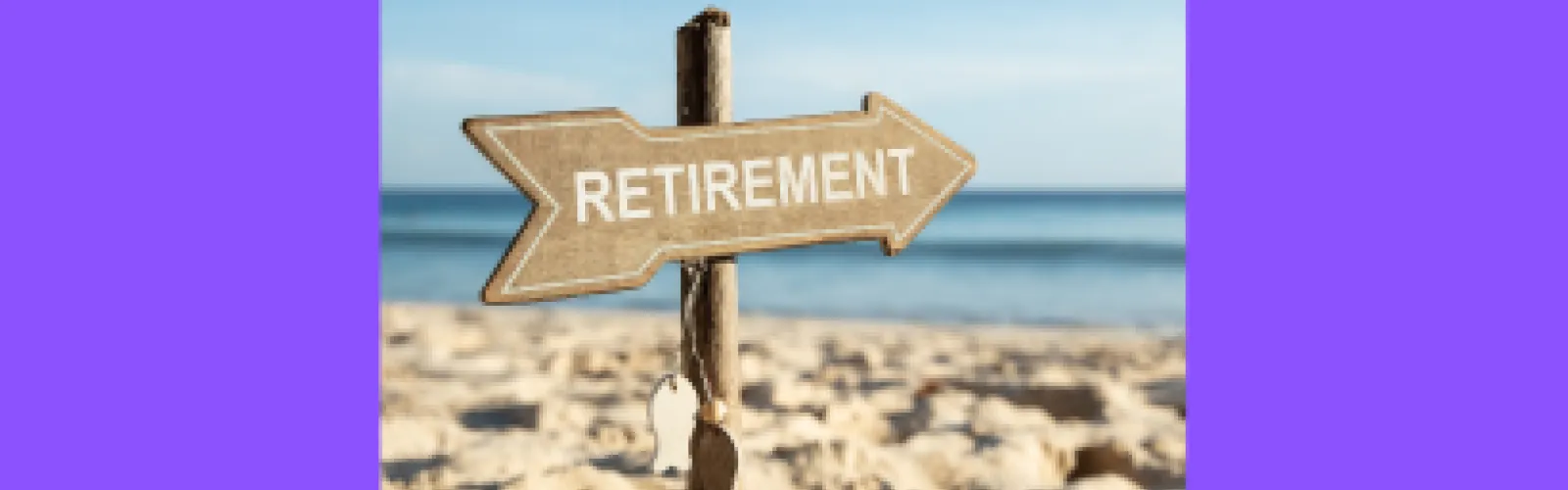 An arrow shaped sign on a beach with the word retirement