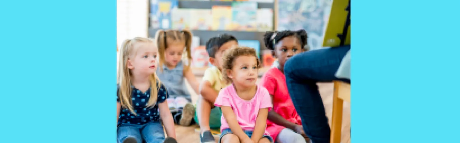 A group of young children listening to a story