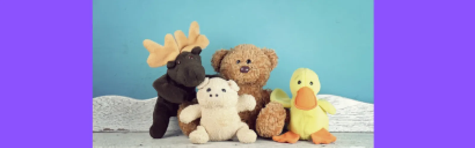 Five stuffed animals sitting in a group