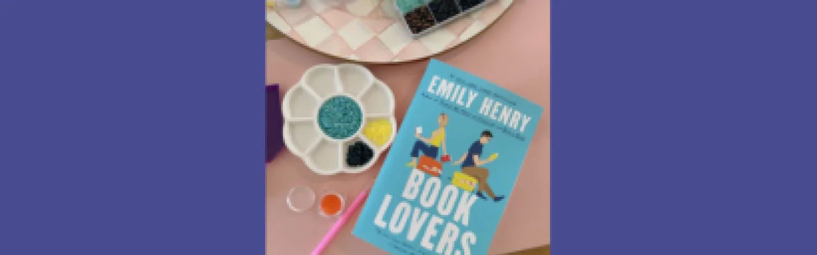 Book cover of Book Covers by Emily Henry and beads in various containers around it
