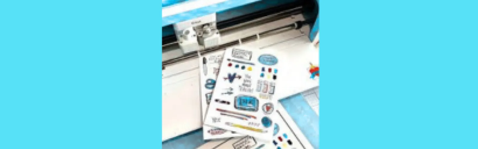 Two sheets of stickers in front of Cricut cutting machine