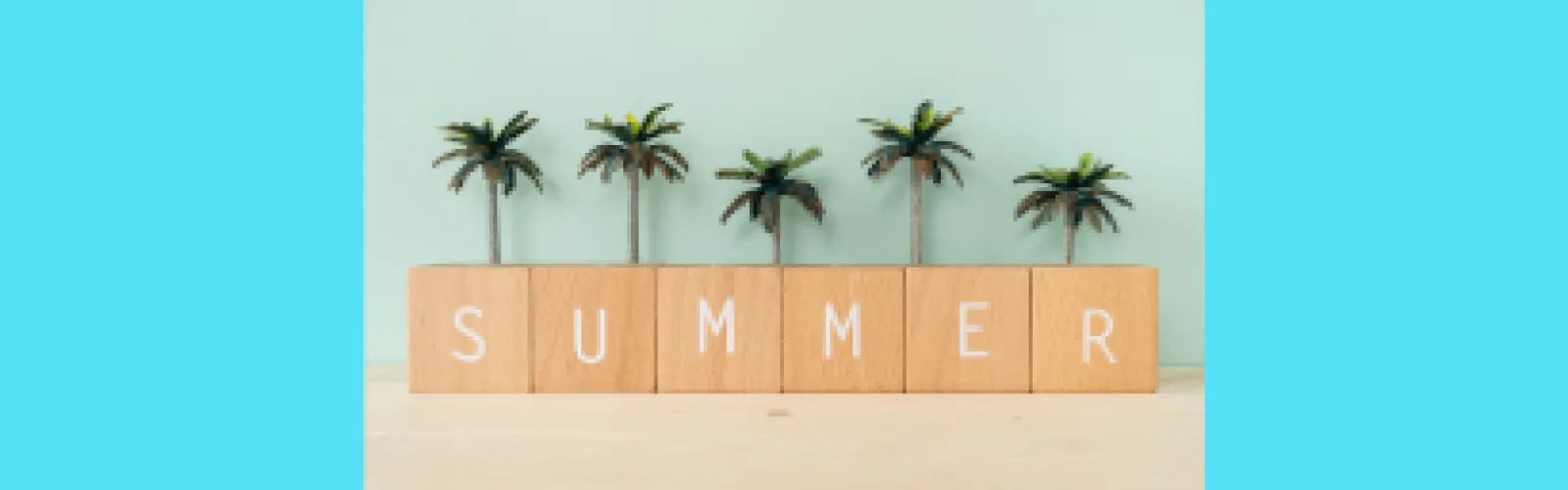 Summer spelled out on tiles with palm trees above