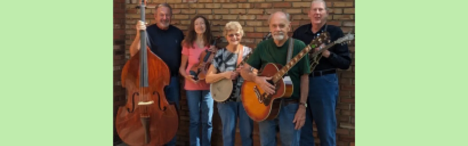 Oak Street String Band members holding their musical instruments