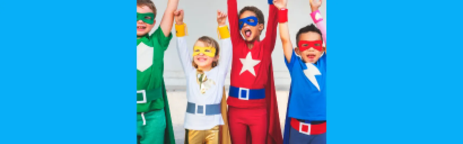 Four children dressed up as superheroes on a blue background