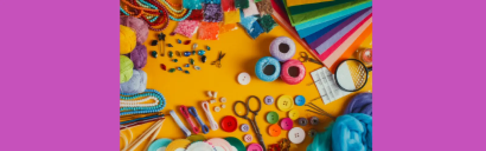A variety of craft supplies displayed on a yellow and purple background 